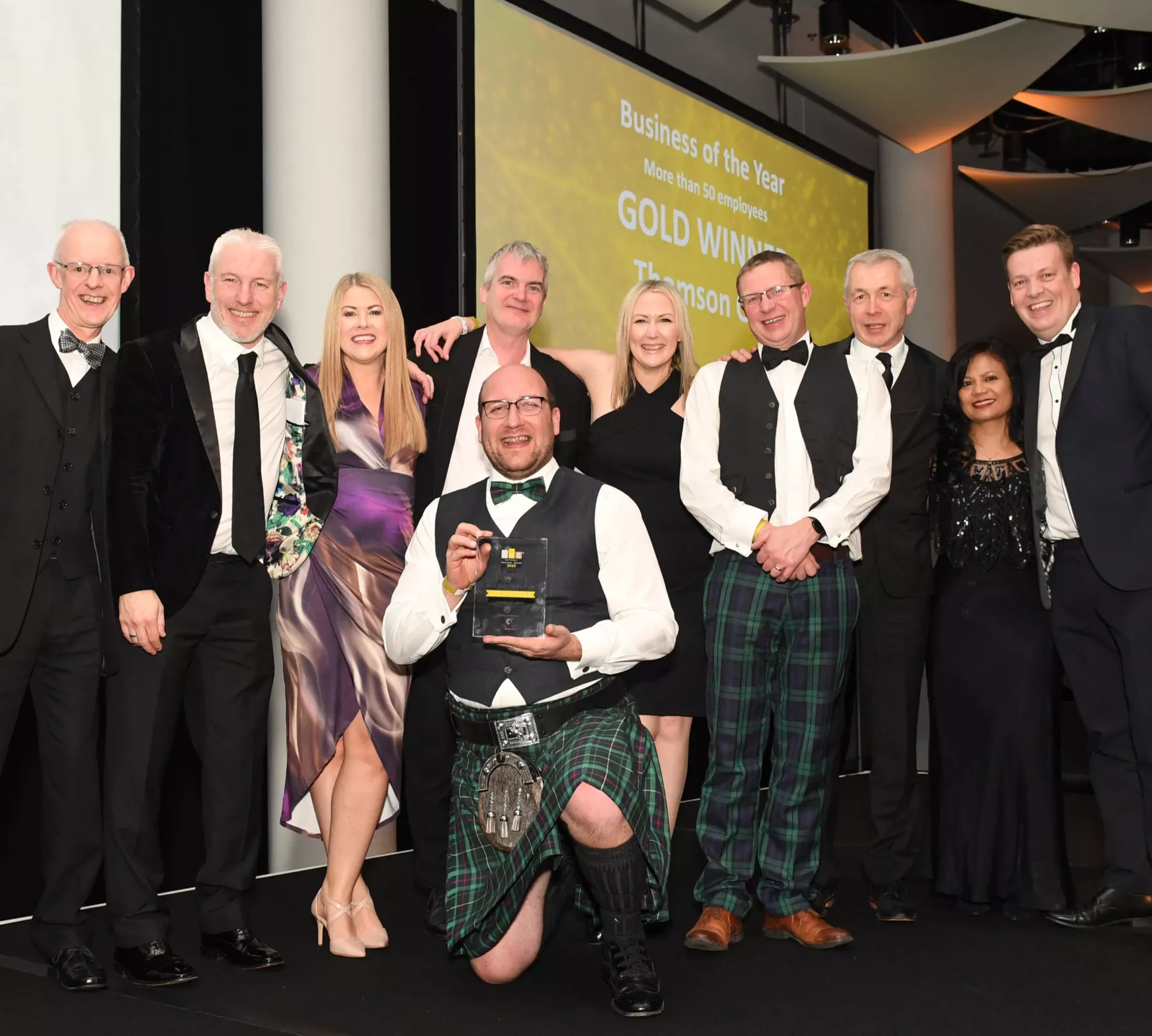 Photograph of members of the Thomson Gray team on stage accepting the gold award for Business of the Year at the National SME Awards at Wembley arena, London.