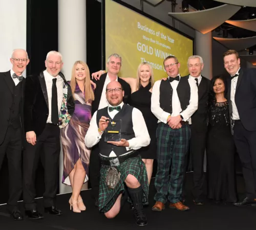 Photograph of members of the Thomson Gray team on stage accepting the gold award for Business of the Year at the National SME Awards at Wembley arena, London.