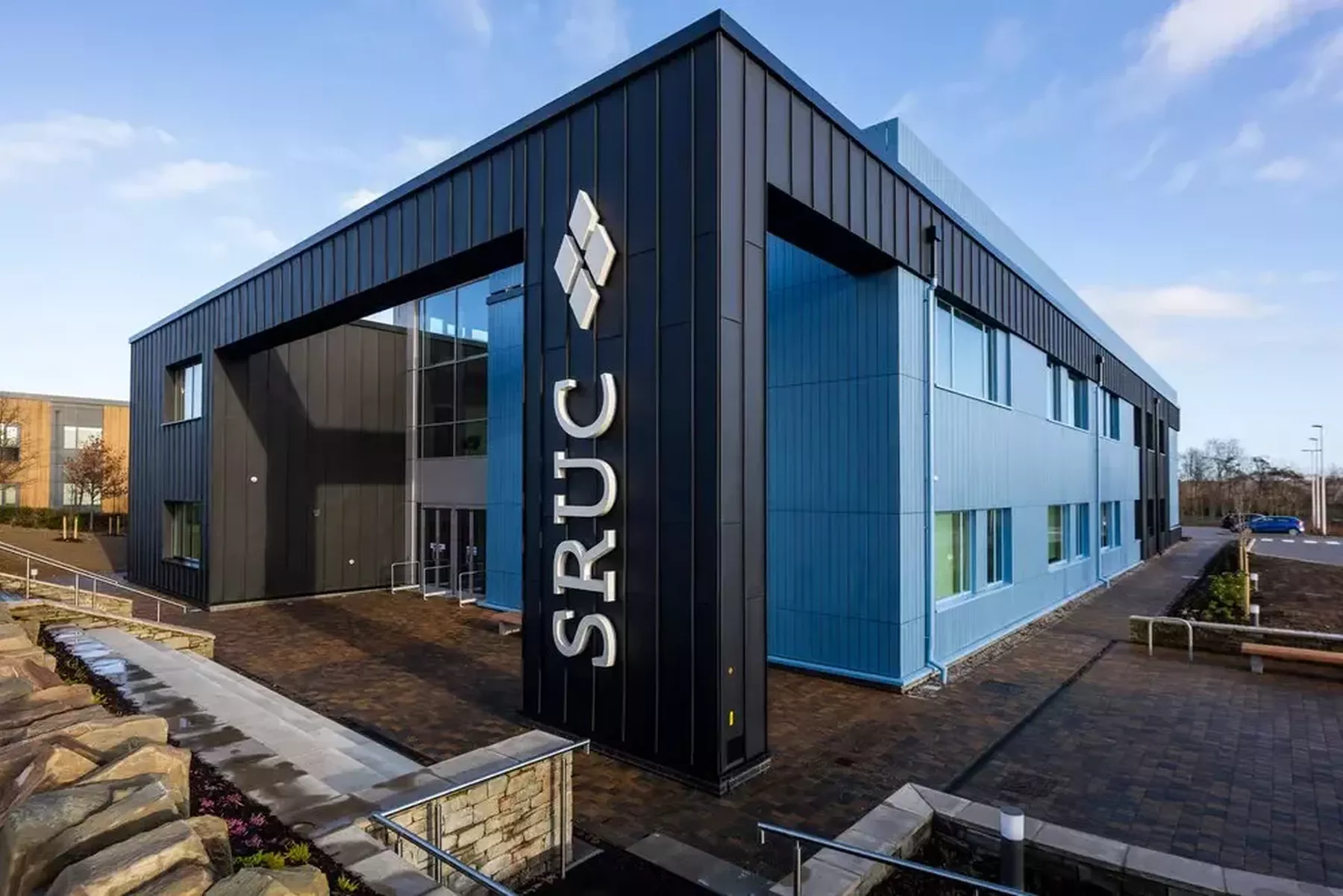 External photograph of the Rural and Veterinary Innovation Centre, a blue building with large SRUC logo on front