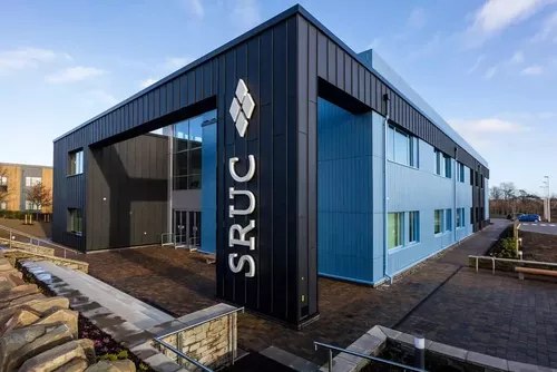 External photograph of the Rural and Veterinary Innovation Centre, a blue building with large SRUC logo on front