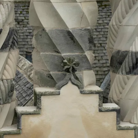 Detailing of neo-gothic sandstone chimneys and rendered gable end at Winton Castle, East Lothian