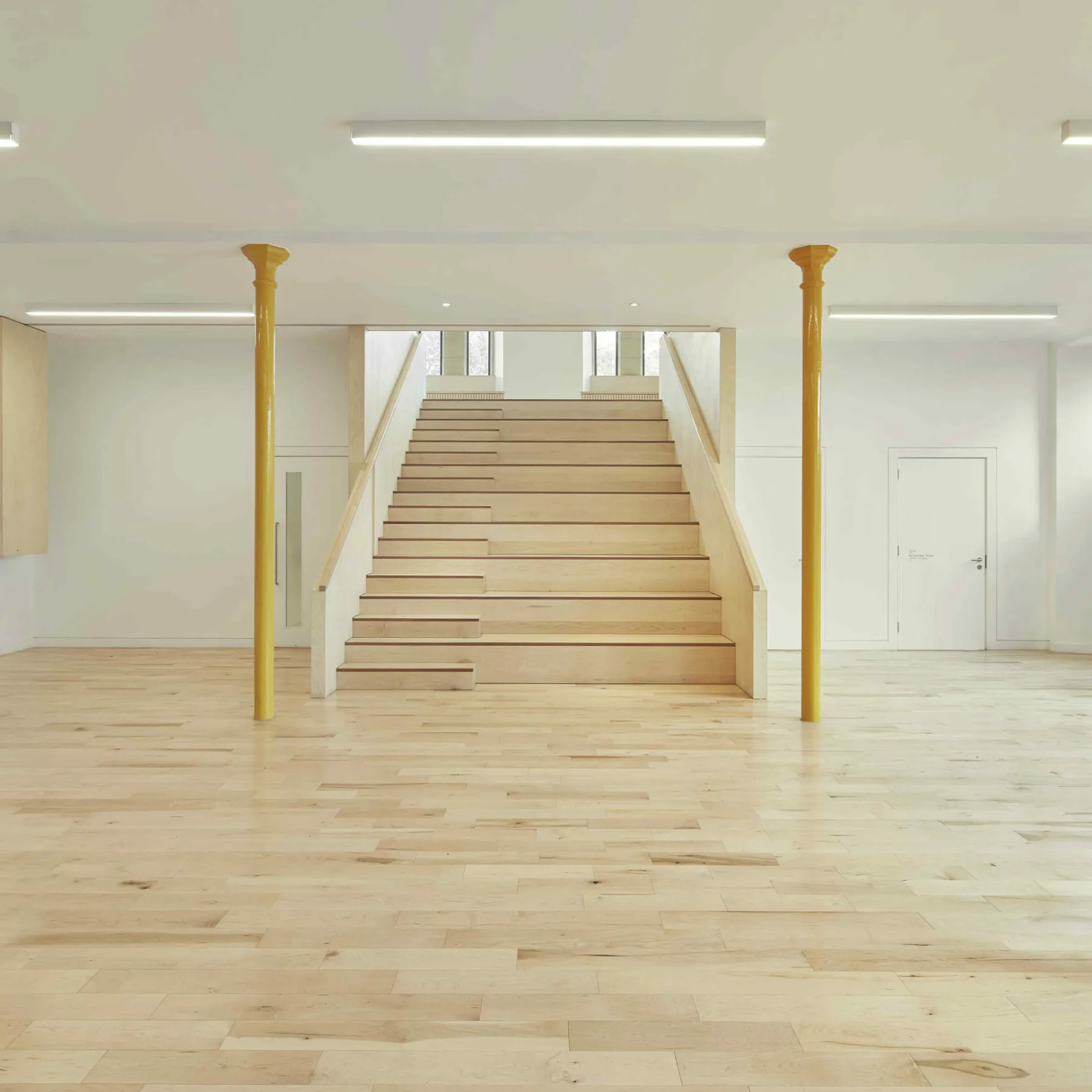 In the undercroft at the Greyfriars Charteris Centre. A flexible and bright space for activities and events in the refurbished and converted former church. Wooden flooring and a wide timber stair case. Original supporting iron columns are painted ochre yellow
