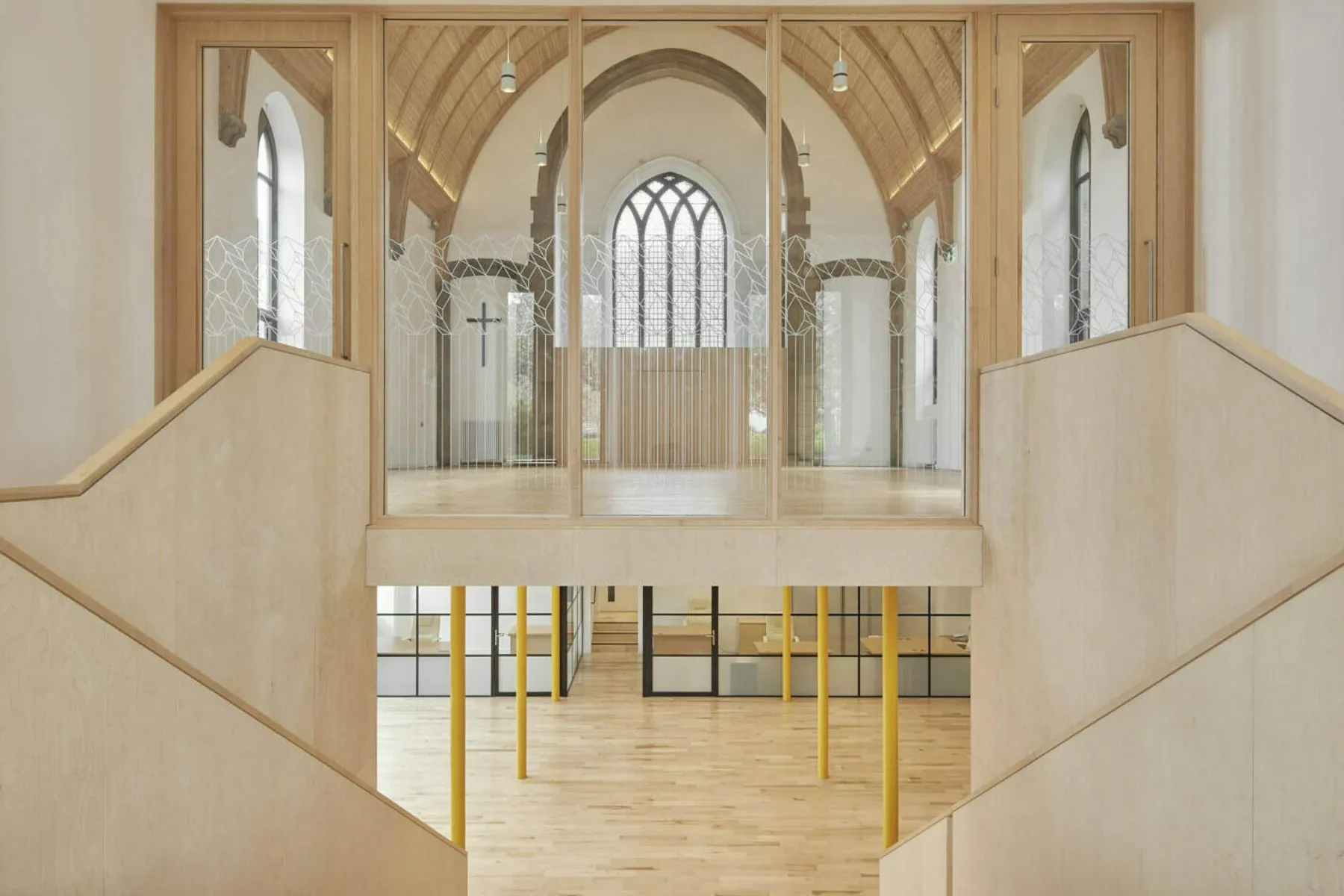Inside the newly refurbished Greyfriars Charteris Centre in Edinburgh. Original features and details have been conserved and repaired an new, contemporary additions have been made - shown is a new timber staircase connecting the upper space in the old church with a lower, flexible and modernised space. Timber is extensively used throughout and the photograph shows both levels of the building.
