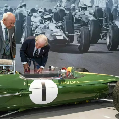 Sir Jackie Stewart examines a green, vintage formula one Lotus  racing car at the opening of the Jim Clark Motorsport Museum, Duns, Scotland.