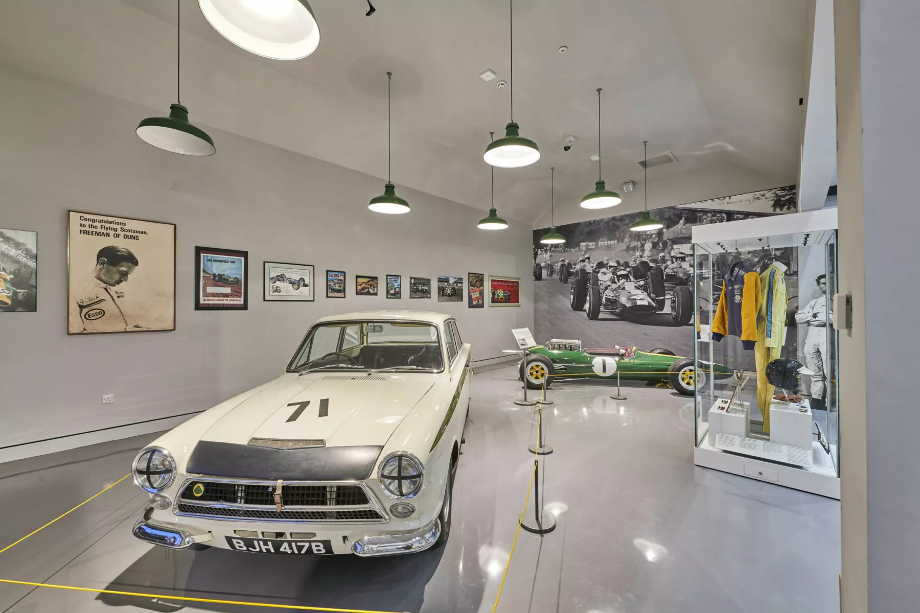 Inside the garages at the Jim Clark Motorsport Museum with vintage racing cars driven by Jim Clark: A Lotus Cortina and a Lotus 25 R6