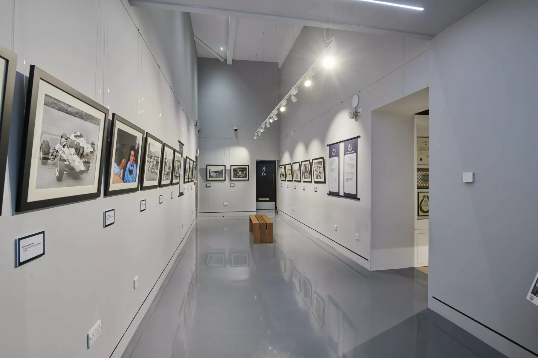 Inside a gallery area at the Jim Clark Motorsport Museum, Scottish Borders. A display of photography is arrange in the tall space.