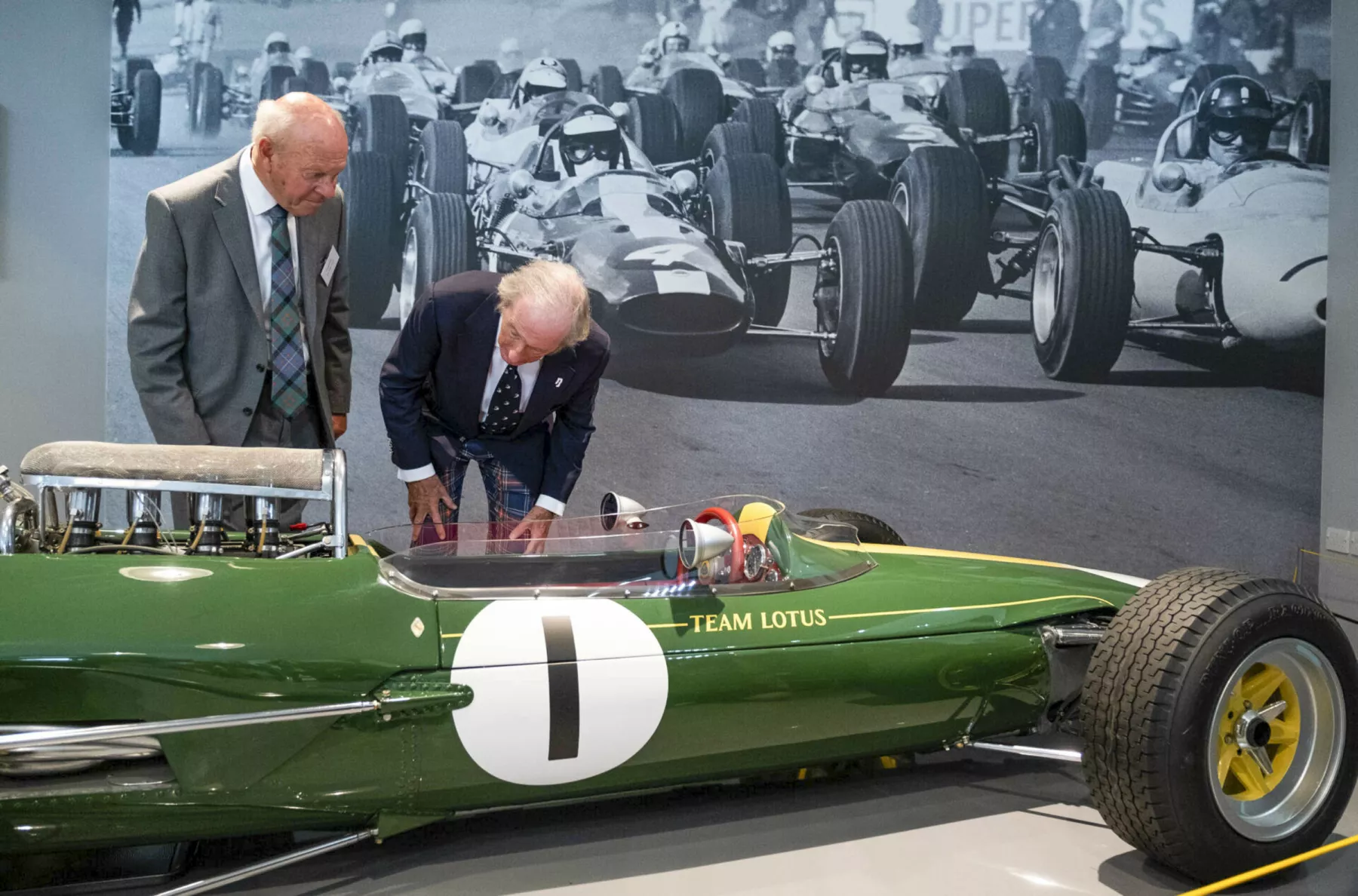 Sir Jackie Stewart examines a green, vintage formula one Lotus racing car (Lotus 25 R6) which was driven by Jim Clark, at the opening of the Jim Clark Motorsport Museum, Duns, Scotland.