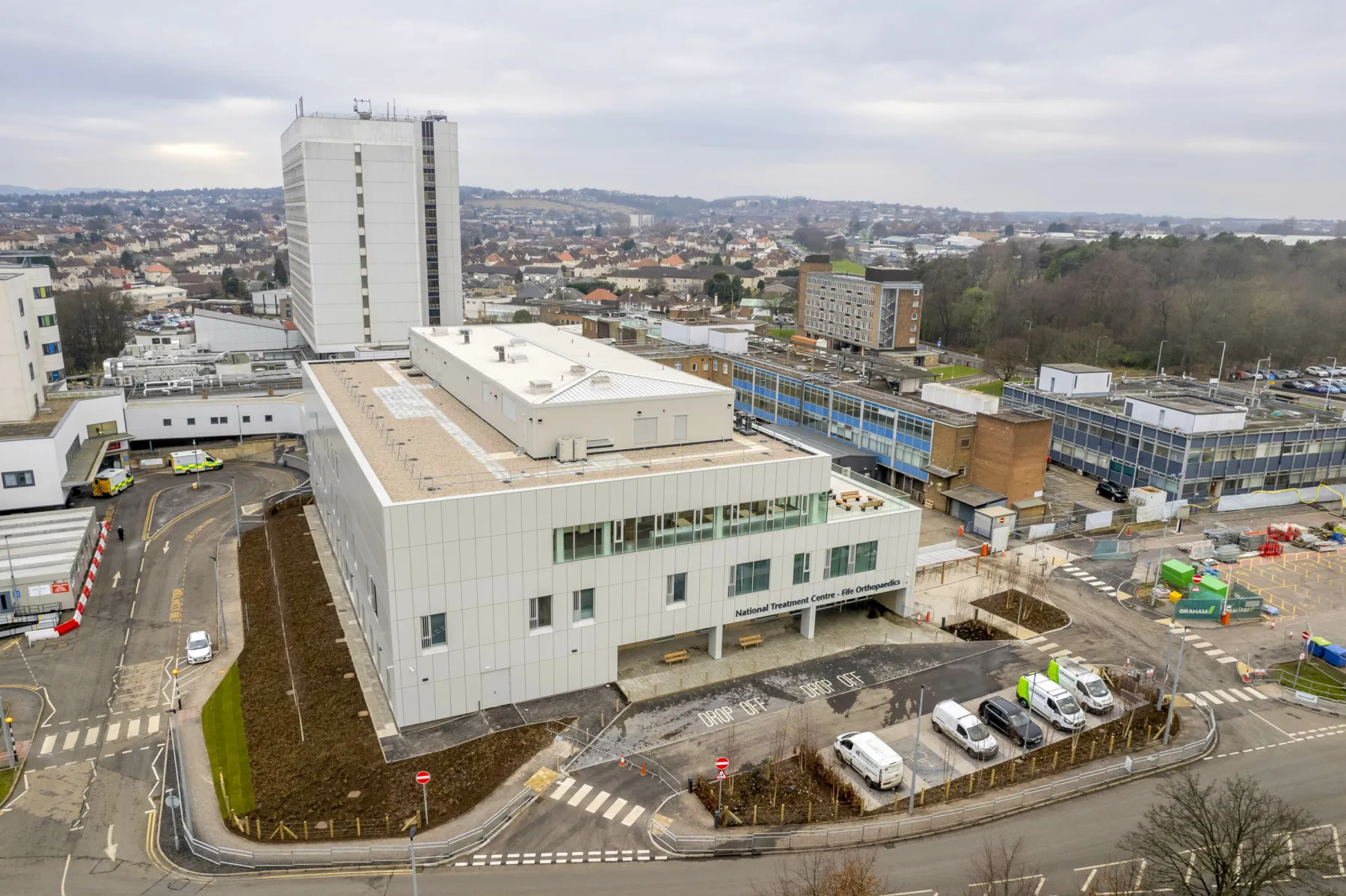 External, aerial view of the National Treatment Centre - Fife Orthopaedics. The building is part of the Kirkcaldy Victoria Hospital campus. The building is white-clad and has three storeys.
