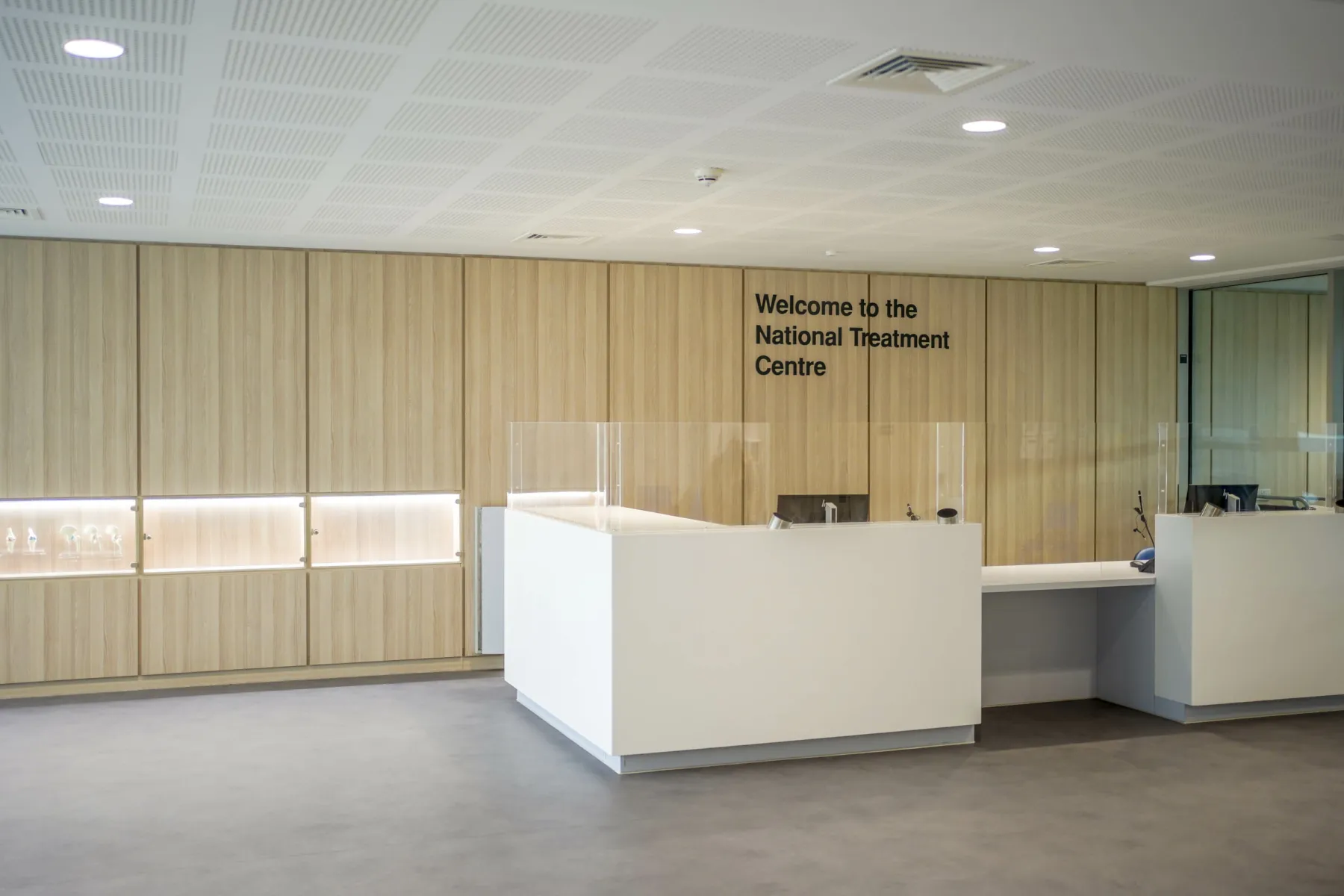 Reception area inside the National Treatment Centre - Fife Orthopaedics. A white reception desk in a large brightly lit space.