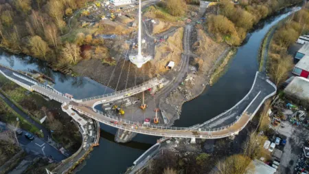 Construction site at Stockingfield Bridge, Glasgow. Pylons and bridge decks are put in place on this curved bridge which joins three areas at a junction in the canal. Shown from above in winter.