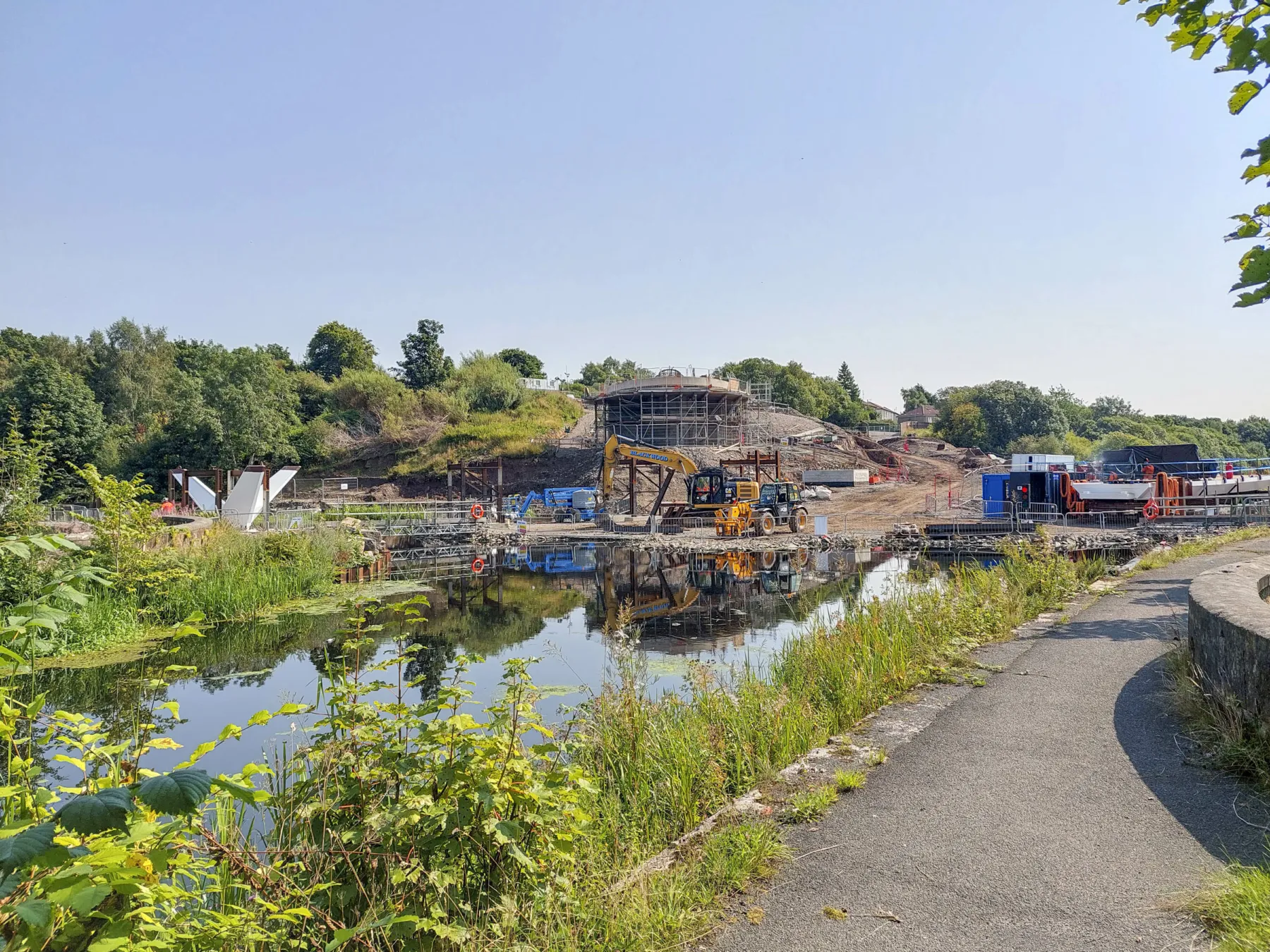 A view from the canal tow path towards the construction site of the Stockingfield Bridge, Glasgow. The tower is in its early stages.
